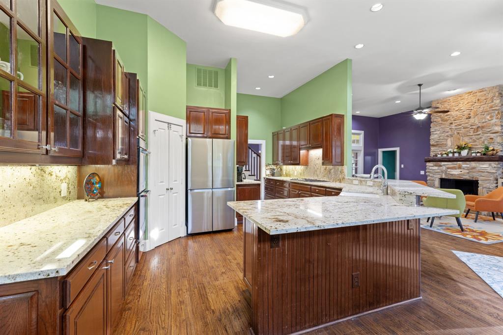 708 Sam Davis Road Argyle, TX 76226 - Photo 16 of 36 a kitchen with stainless steel appliances granite countertop a kitchen island a stove and a sink