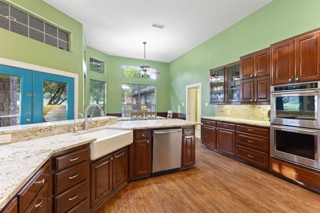 708 Sam Davis Road Argyle, TX 76226 - Photo 17 of 36 a large kitchen with stainless steel appliances granite countertop a sink and a stove
