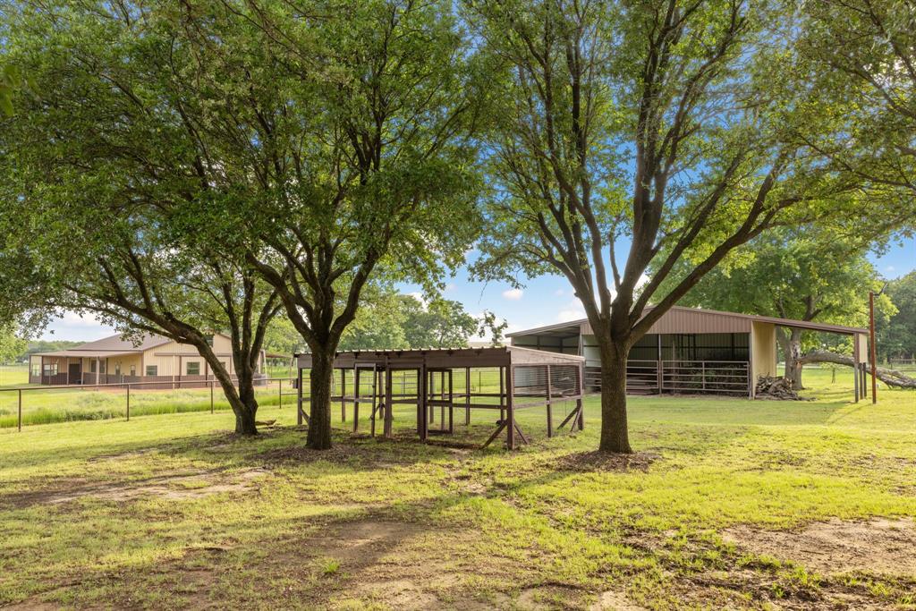 708 Sam Davis Road Argyle, TX 76226 - Photo 29 of 36 a view of a house with large trees and a big yard