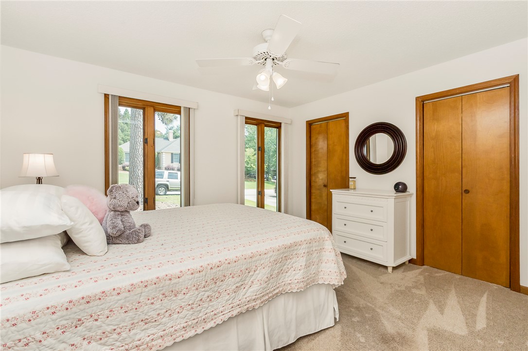 207 Laurel Ridge Road Anderson, SC 29621 - Photo 27 of 50 Natural light streams into this bedroom through French doors, illuminating the neutral carpet.