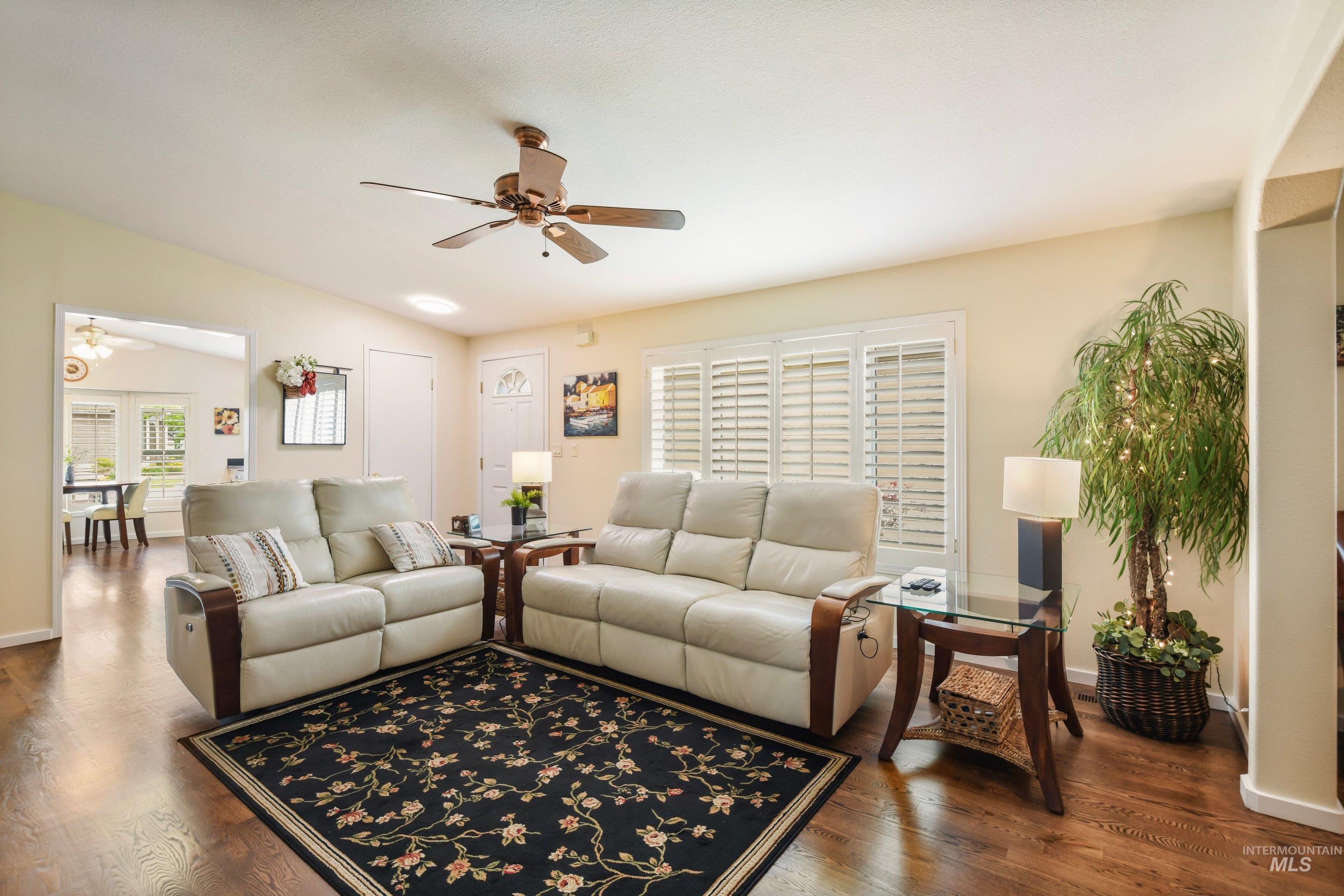 421 South Curtis Road, Unit 202 202 Boise, ID 83705 - Photo 7 of 41 Living space featuring wood-finish flooring, white plantation shutters, and a ceiling fan with integrated lighting
