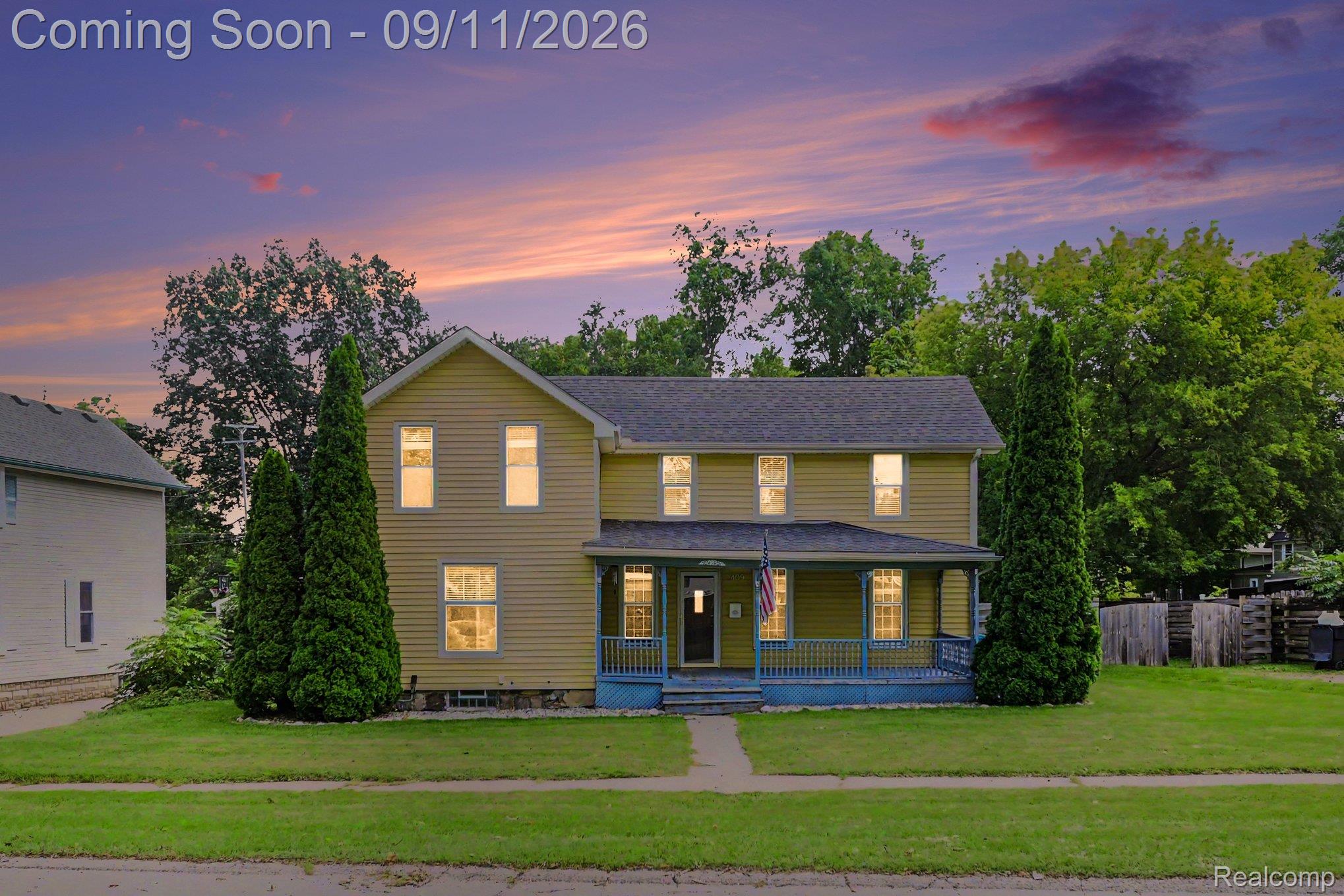 409 Fleming Street Howell, MI 48843 - Photo 1 of 25 Two-story exterior with yellow siding, covered front porch, and a dark shingle roof