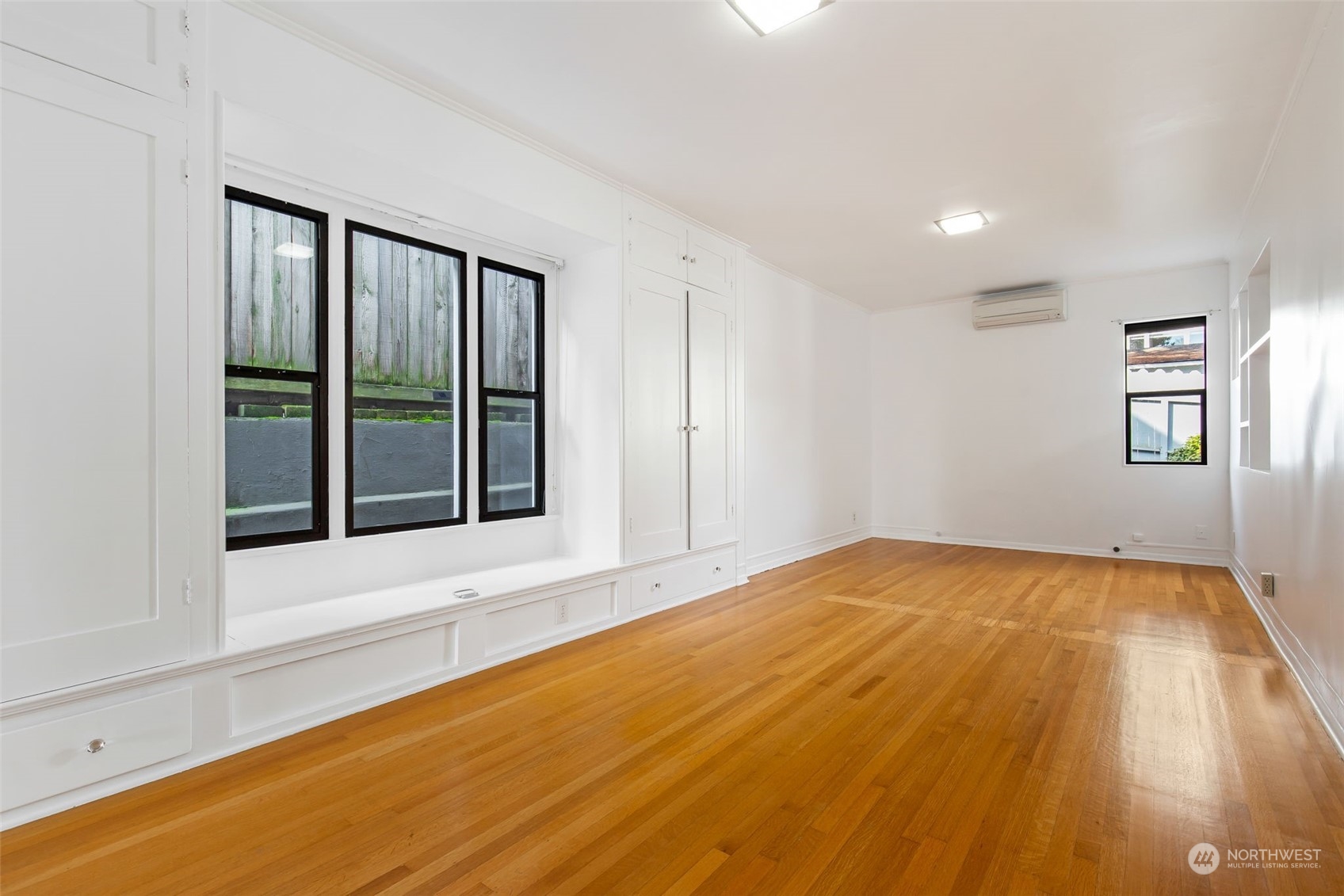 1941 15th Avenue East Seattle, WA 98112 - Photo 15 of 37 a view of an empty room with window and wooden floor