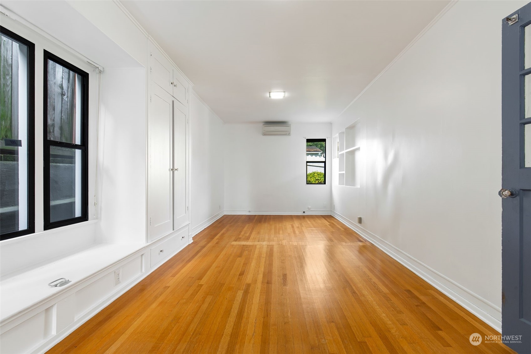 1941 15th Avenue East Seattle, WA 98112 - Photo 16 of 37 a view of a room with wooden floor and windows