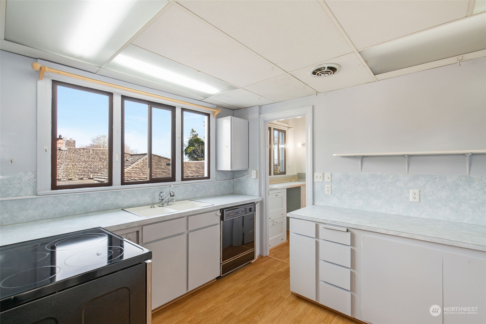 1941 15th Avenue East Seattle, WA 98112 - Photo 21 of 37 a kitchen with a sink window and cabinets