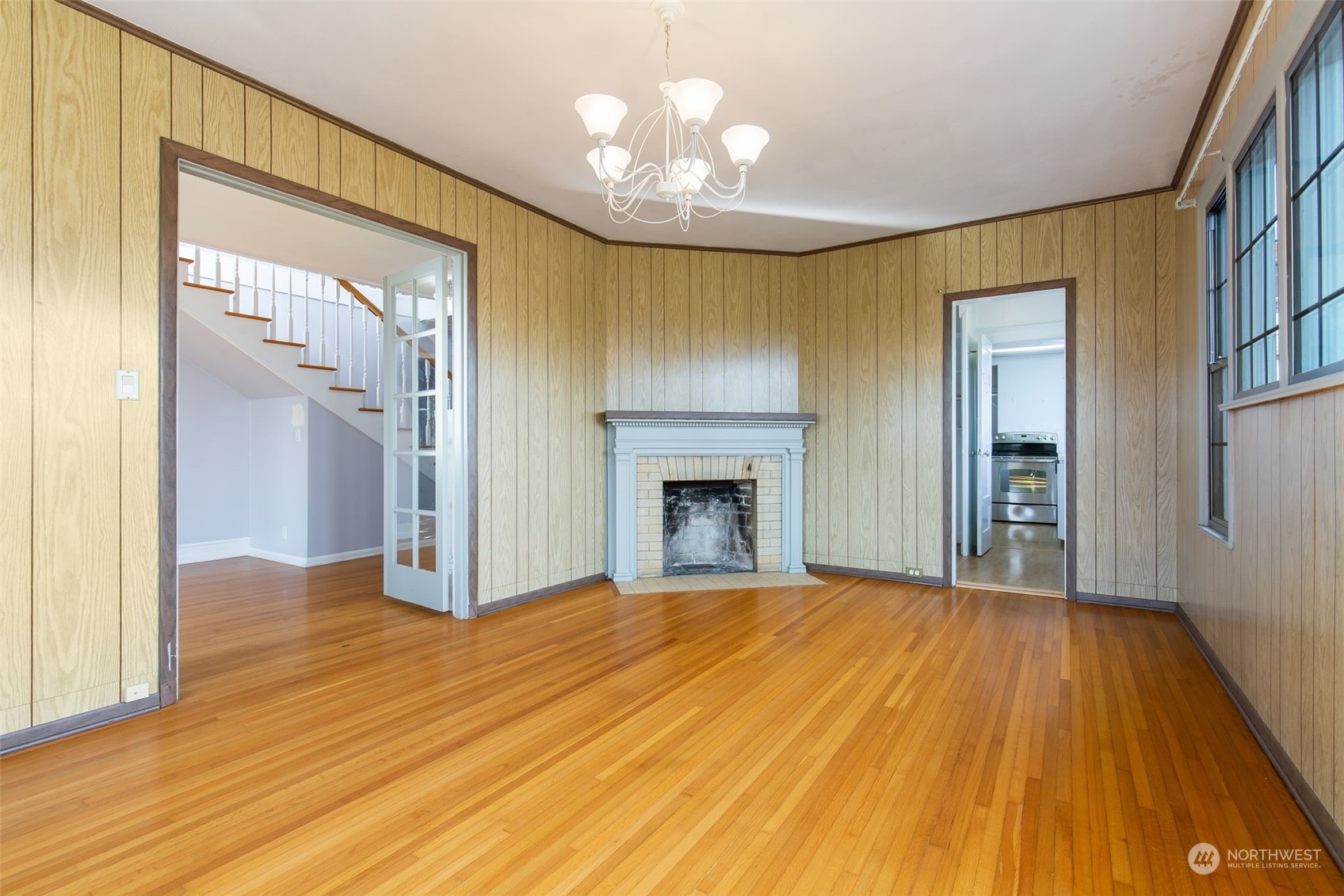 1941 15th Avenue East Seattle, WA 98112 - Photo 7 of 37 a view of an empty room with wooden floor and a fireplace