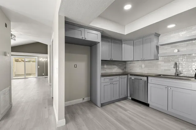 an empty room with windows and wooden floor