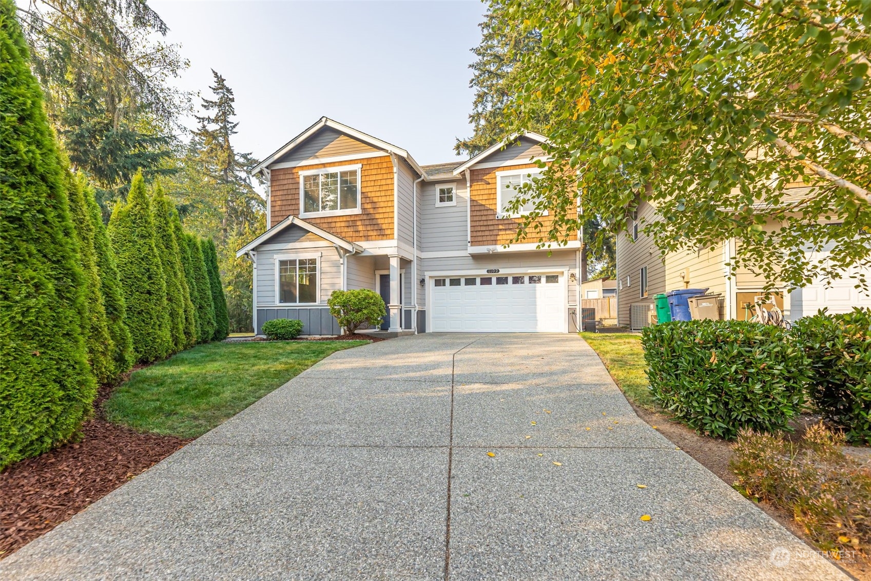 1102 120th Street Southeast Everett, WA 98208 - Photo 1 of 28 a front view of a house with a yard and garage