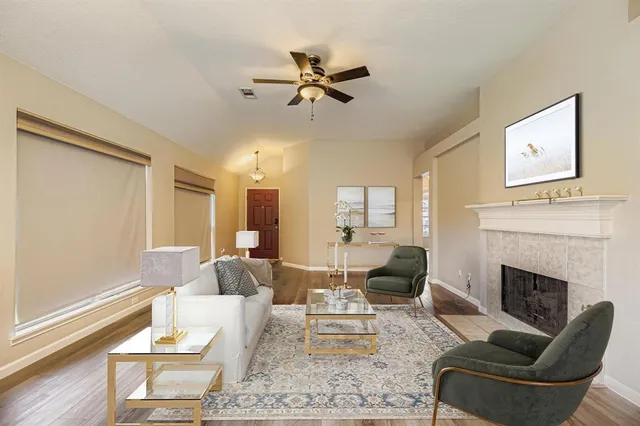 a living room with furniture fireplace and a window