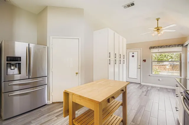 a kitchen with stainless steel appliances a refrigerator and a stove top oven