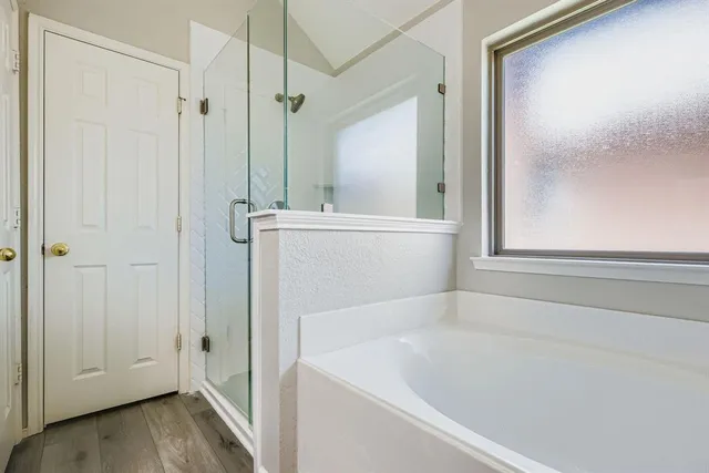 a bathroom with a bathtub and a shower