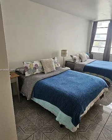a bed sitting in a bedroom next to a window