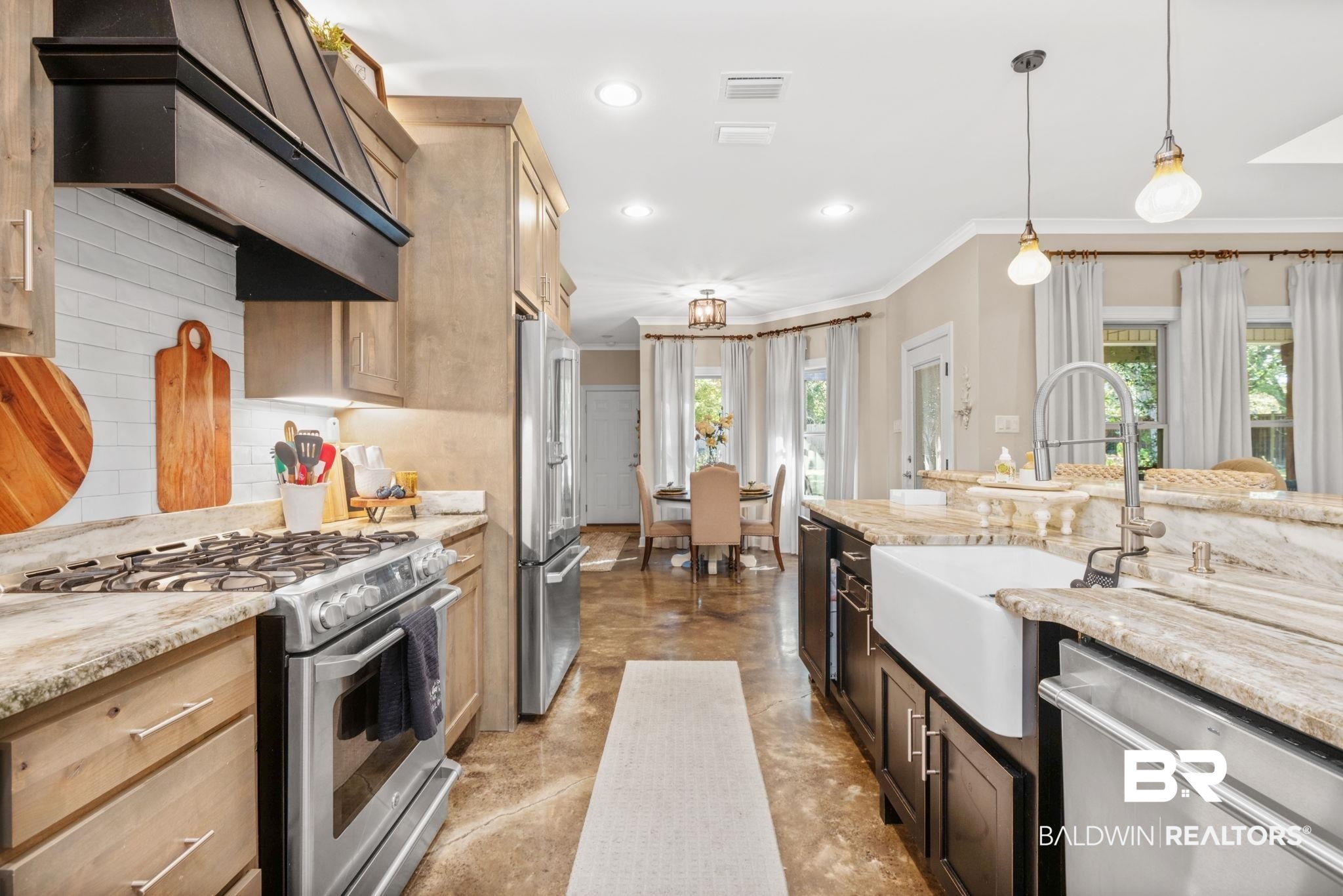 4331 Hamilton Oaks Lane Mobile, AL 36695 - Photo 10 of 38 Kitchen featuring stainless steel appliances, a sink, crown molding, healthy amount of natural light, and finished concrete floors