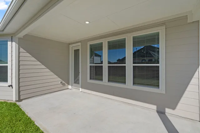 a view of an entrance to house with yard