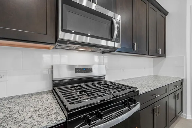 a stove top oven sitting inside of a kitchen