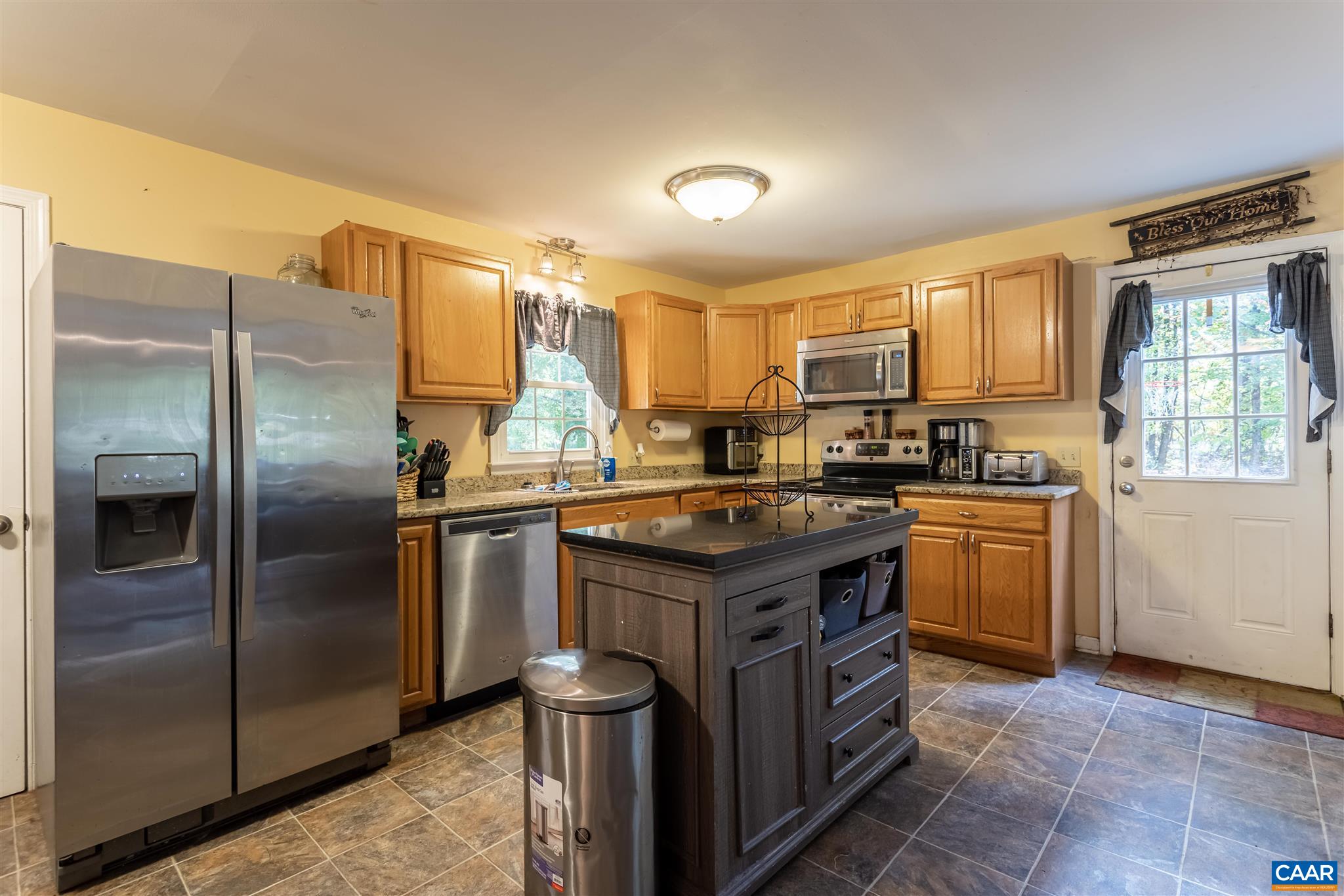 2588 South Blue Ridge Turnpike Rochelle, VA 22738 - Photo 11 of 30 a kitchen with kitchen island granite countertop a sink stove and refrigerator