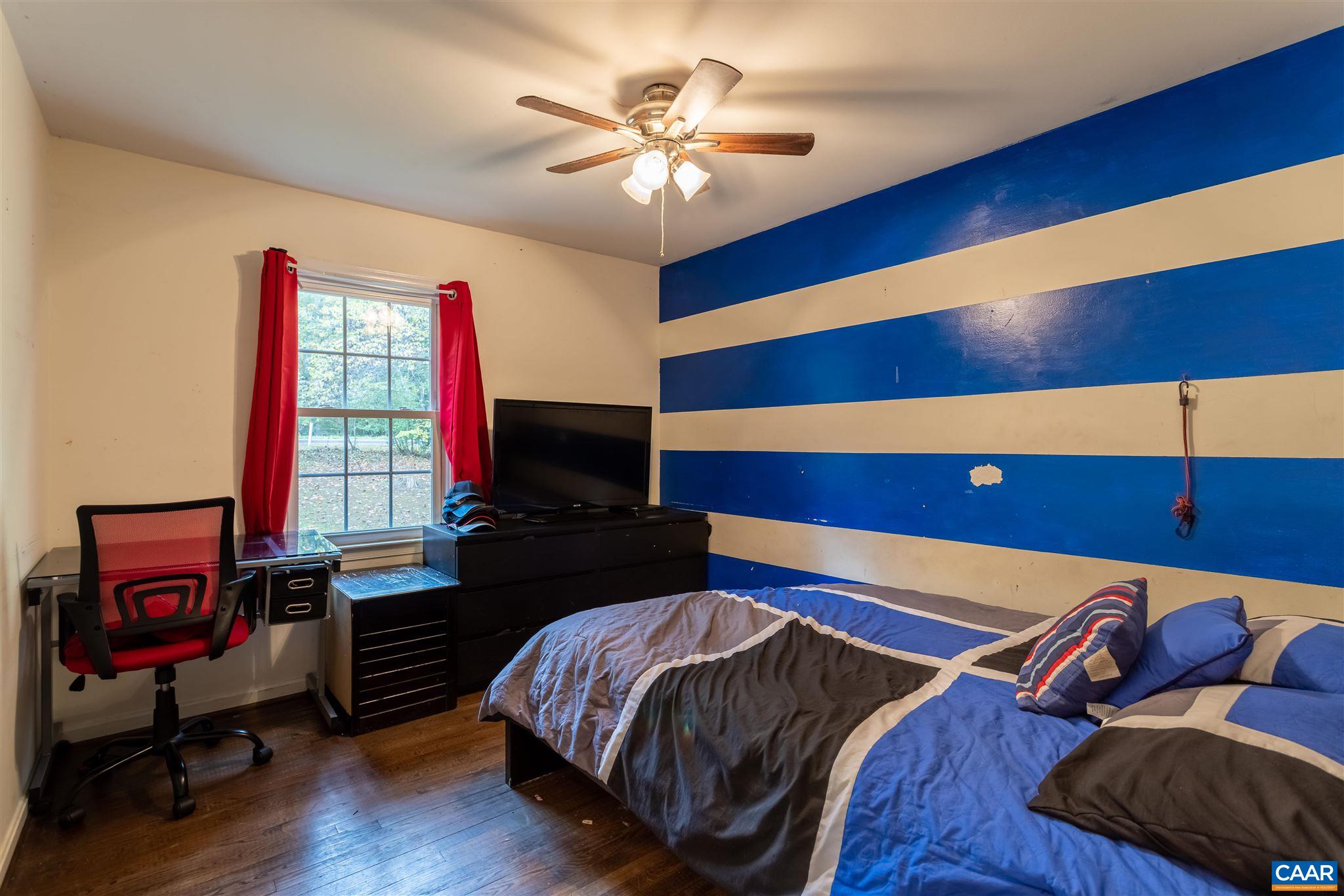 2588 South Blue Ridge Turnpike Rochelle, VA 22738 - Photo 16 of 30 a bedroom with a bed and a flat screen tv