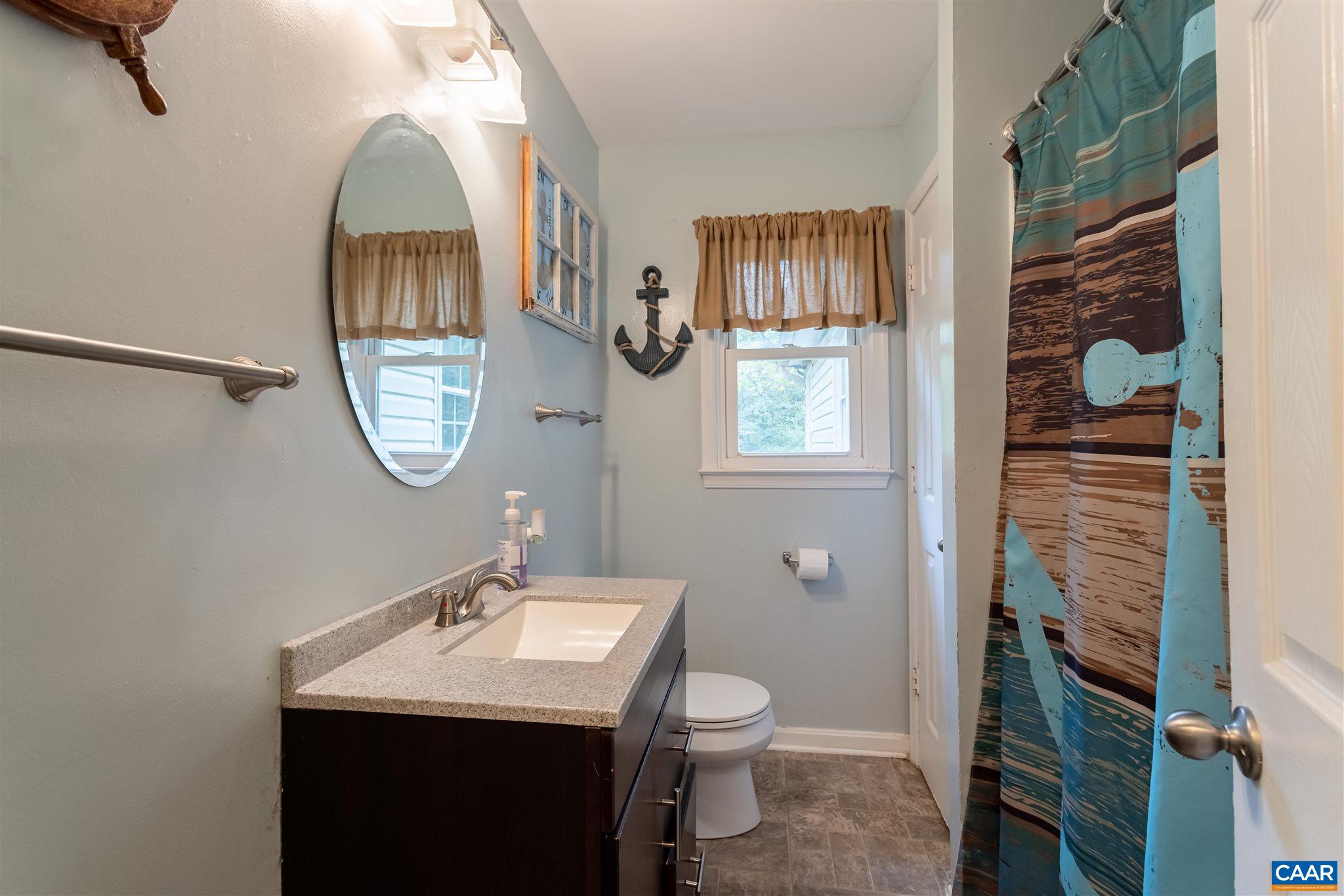 2588 South Blue Ridge Turnpike Rochelle, VA 22738 - Photo 17 of 30 a bathroom with a toilet a sink and a mirror