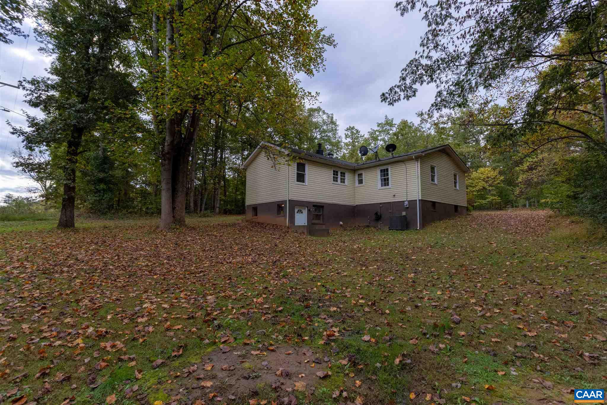 2588 South Blue Ridge Turnpike Rochelle, VA 22738 - Photo 2 of 30 a view of a house with a yard and large trees