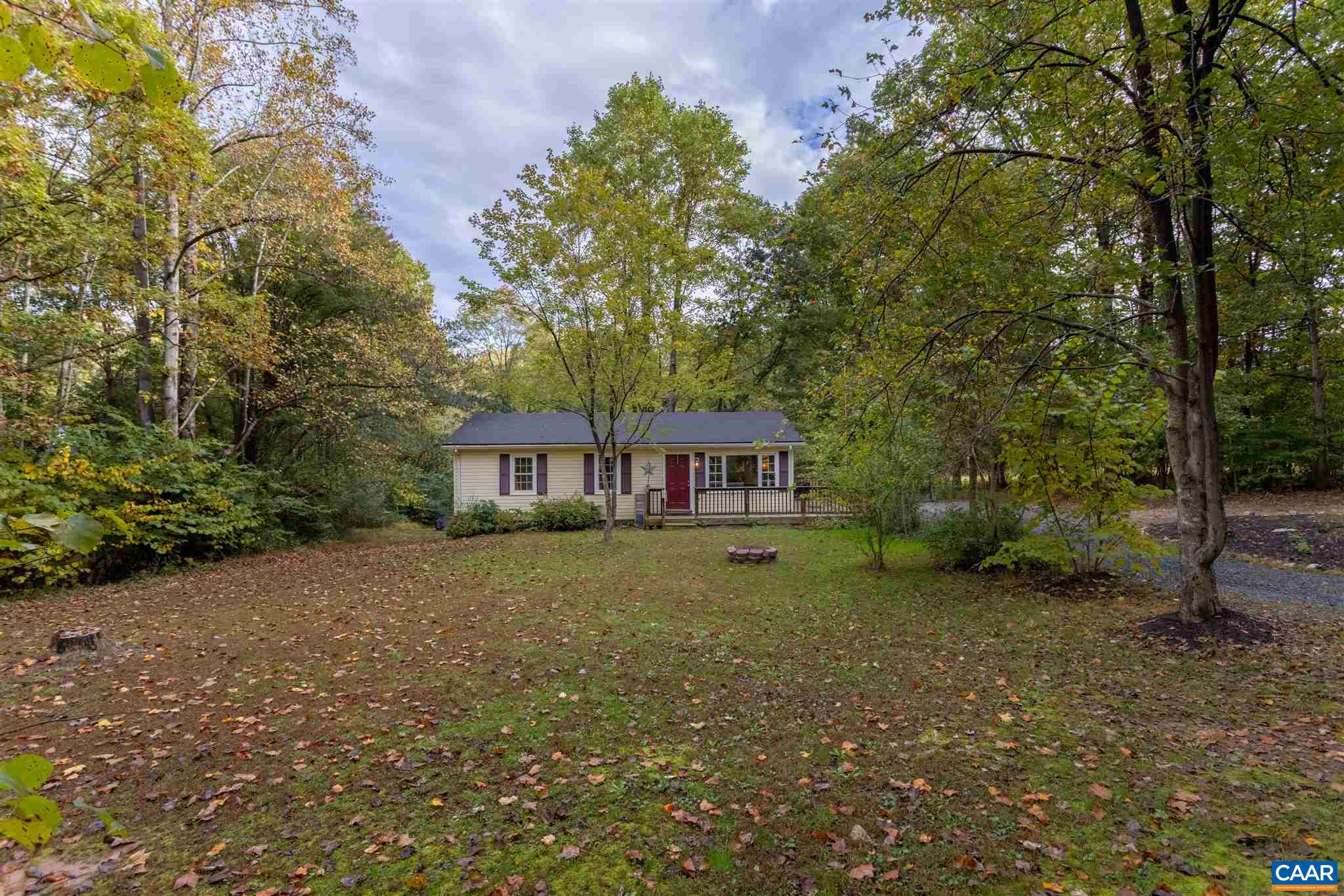 2588 South Blue Ridge Turnpike Rochelle, VA 22738 - Photo 22 of 30 a view of a yard in front of a house with large trees