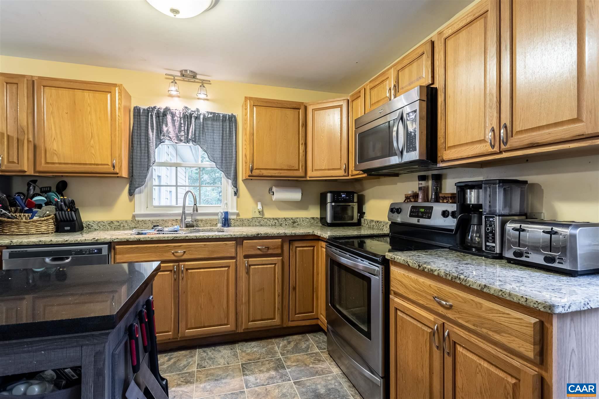 2588 South Blue Ridge Turnpike Rochelle, VA 22738 - Photo 10 of 30 a kitchen with stainless steel appliances granite countertop a sink a stove cabinets counter space and a window