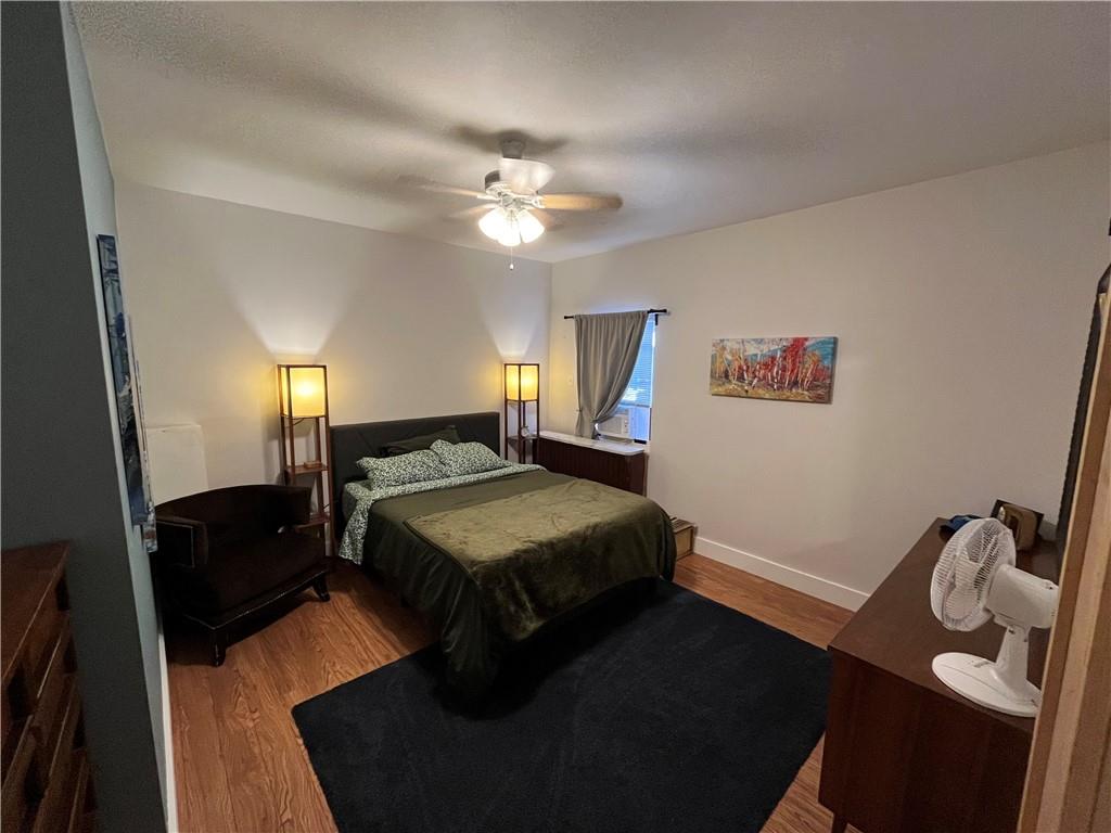1716 Snow Way Pittsburgh, PA 15206 - Photo 15 of 21 a bedroom with a bed and dresser with mirror