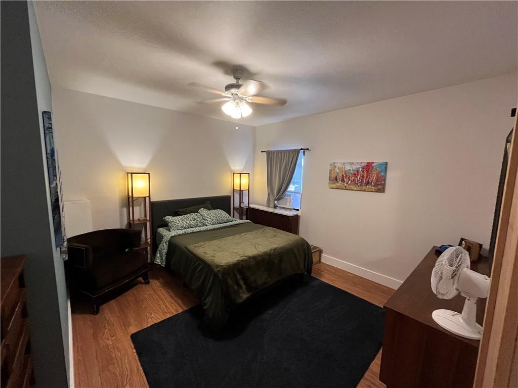 1716 Snow Way Pittsburgh, PA 15206 - Photo 16 of 21 a bedroom with a bed and a chandelier
