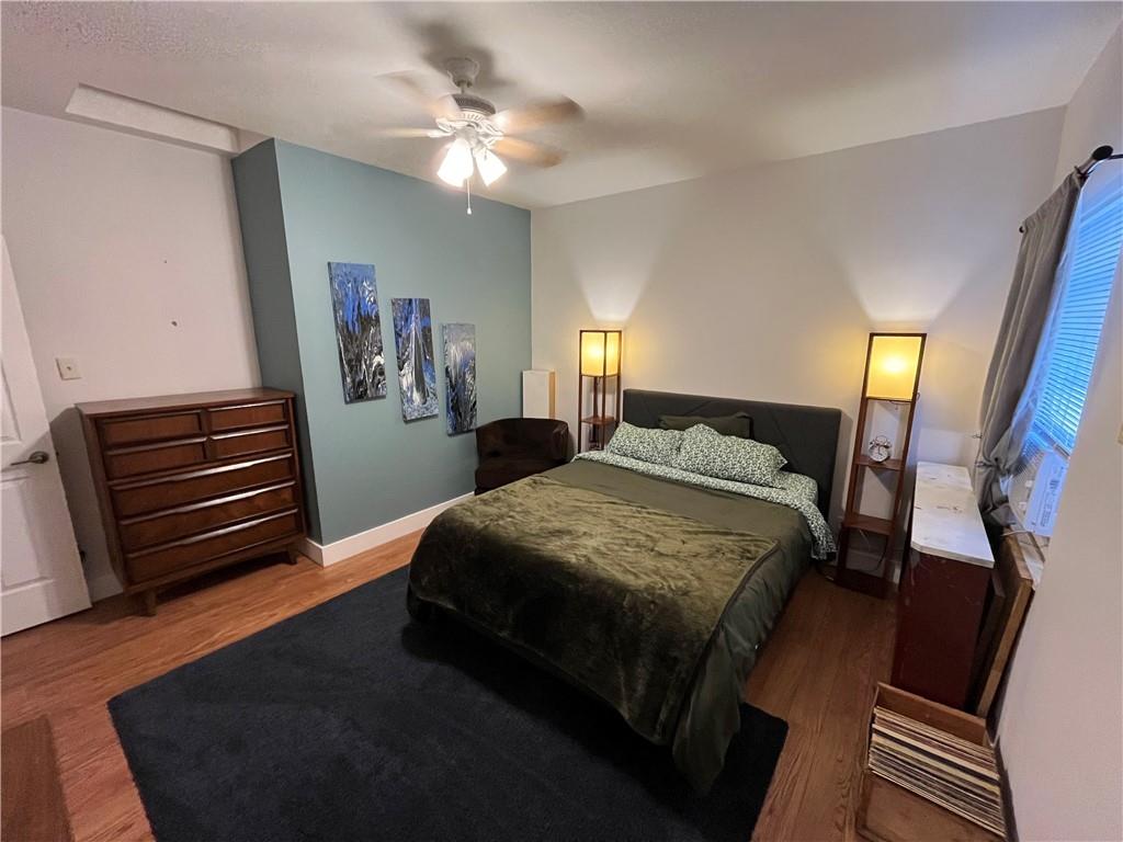 1716 Snow Way Pittsburgh, PA 15206 - Photo 17 of 21 a spacious bedroom with a bed and a chandelier