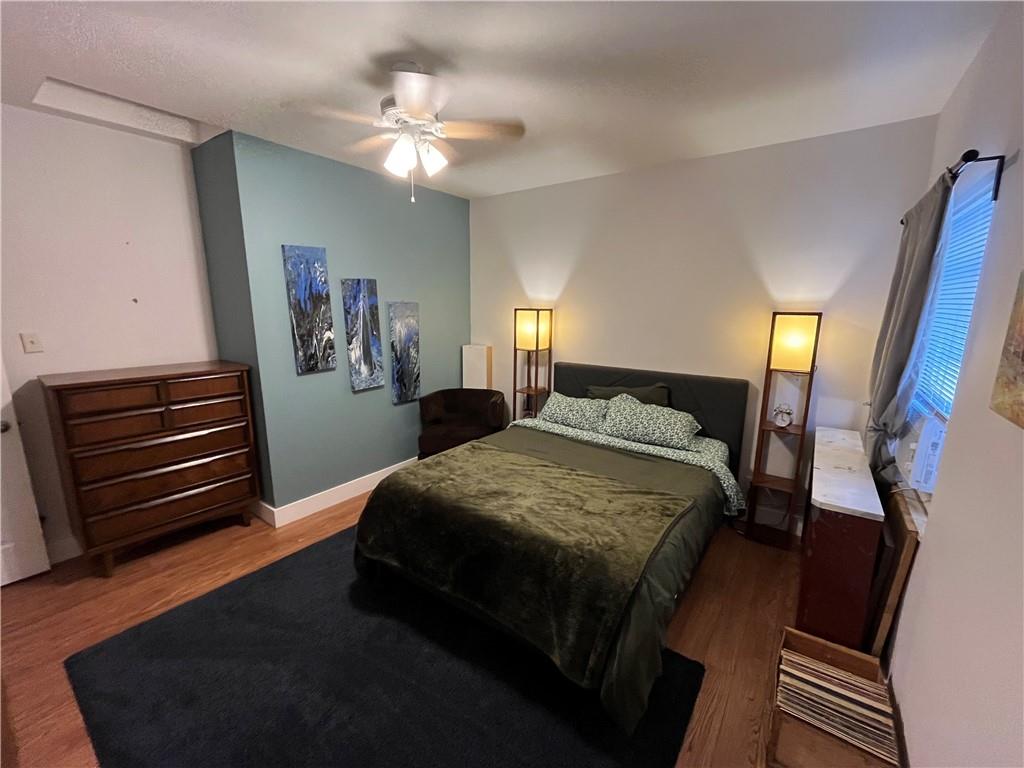 1716 Snow Way Pittsburgh, PA 15206 - Photo 18 of 21 a bedroom with a bed and a chandelier
