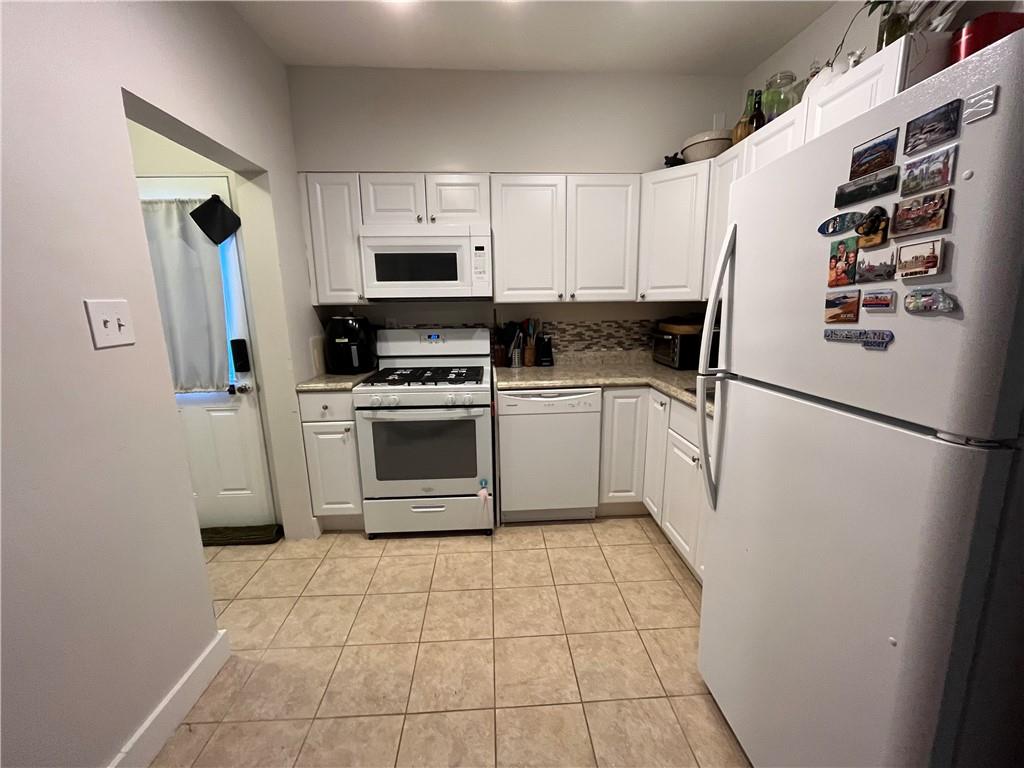 1716 Snow Way Pittsburgh, PA 15206 - Photo 5 of 21 a refrigerator freezer and a stove sitting inside of a kitchen