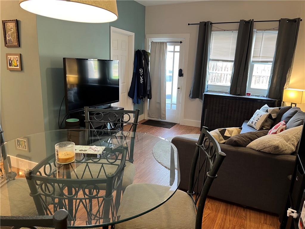 1716 Snow Way Pittsburgh, PA 15206 - Photo 10 of 21 a living room with furniture a flat screen tv and a floor to ceiling window