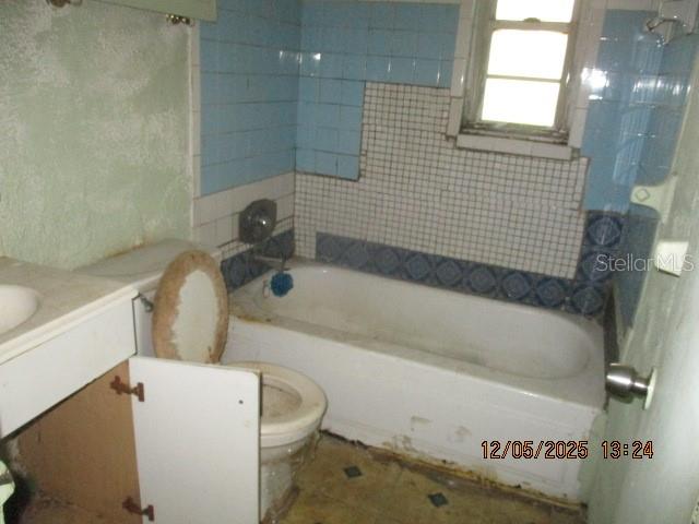 4175 Covington Street Orlando, FL 32811 - Photo 11 of 19 a bathroom with a sink a toilet and bathtub