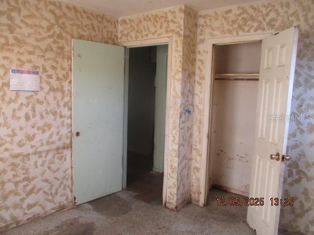4175 Covington Street Orlando, FL 32811 - Photo 16 of 19 a view of room with walk in closet and window