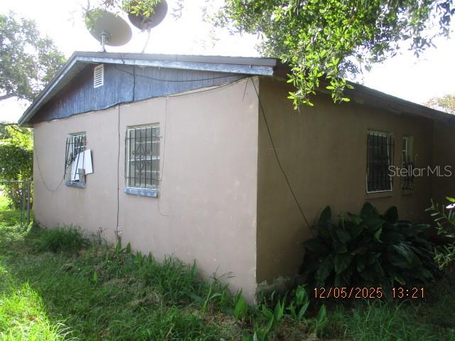 4175 Covington Street Orlando, FL 32811 - Photo 4 of 19 a house that has a tree in front of it