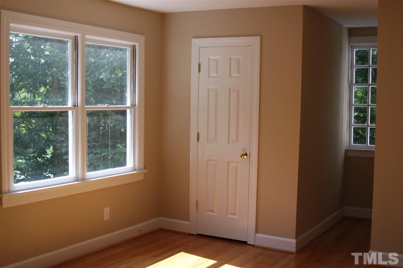8305 Harps Mill Road Raleigh, NC 27615 - Photo 14 of 19 a view of front door with wooden floor