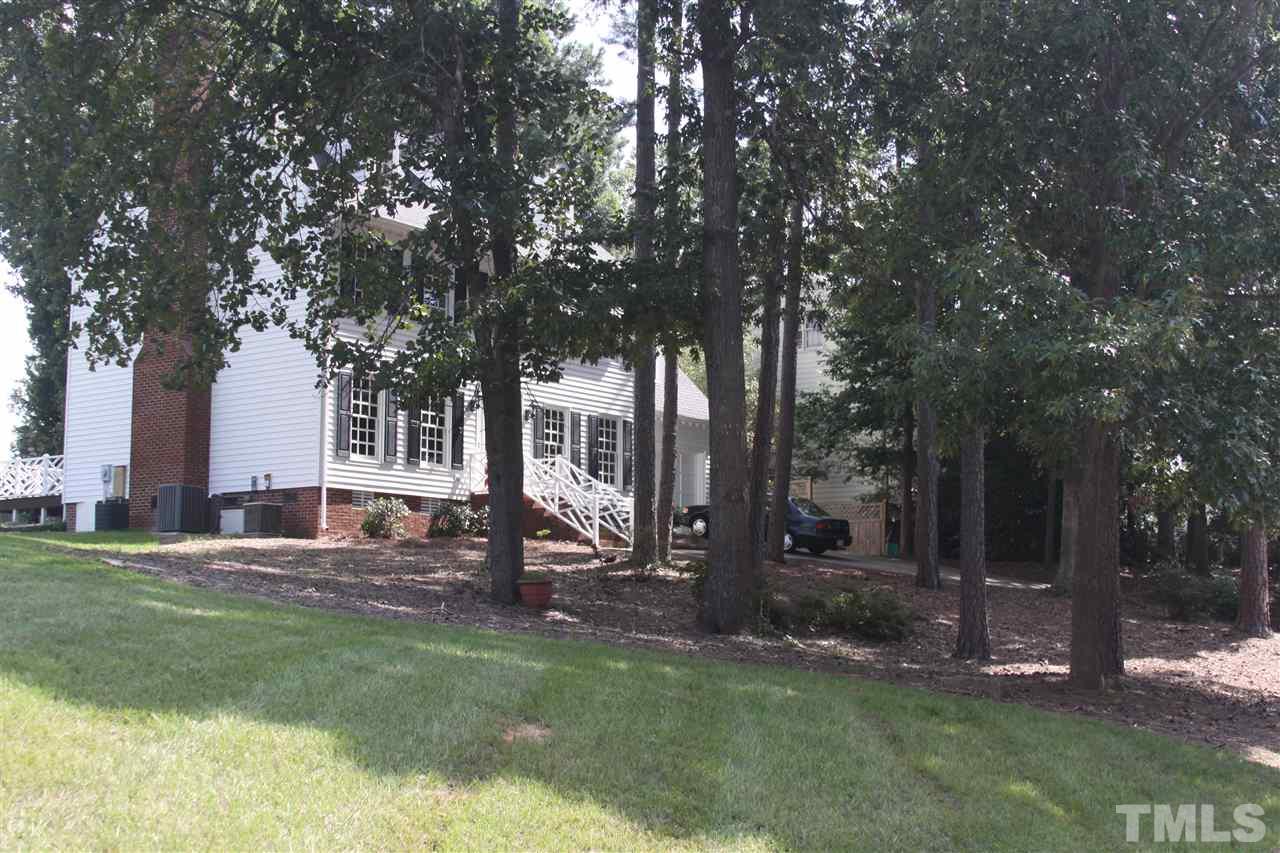 8305 Harps Mill Road Raleigh, NC 27615 - Photo 4 of 19 a view of a house with backyard and sitting area