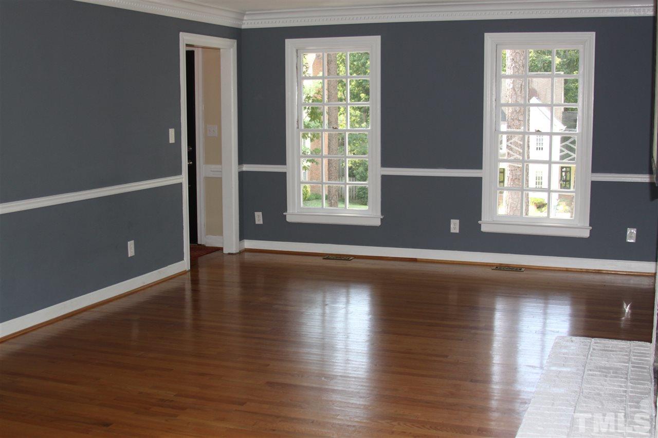 8305 Harps Mill Road Raleigh, NC 27615 - Photo 8 of 19 an empty room with wooden floor and windows