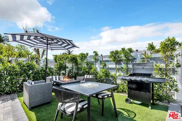 a view of a chairs and table in the patio