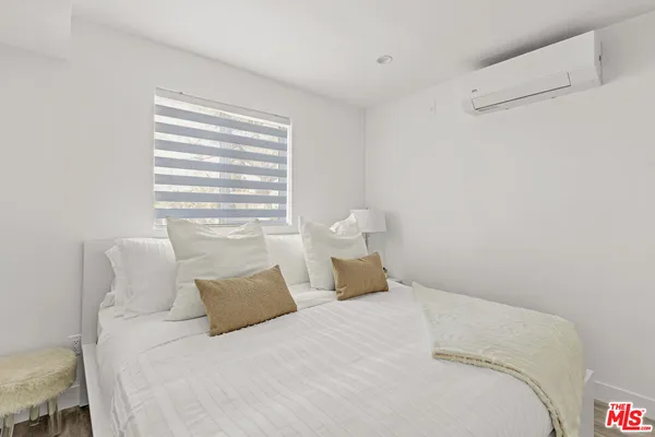 a bedroom with a bed and a night stand