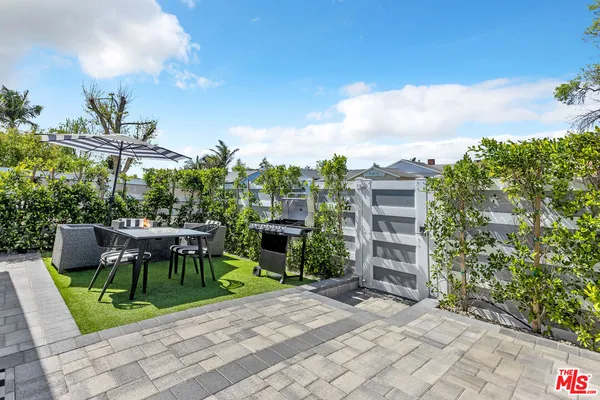 a view of a backyard with plants and a patio