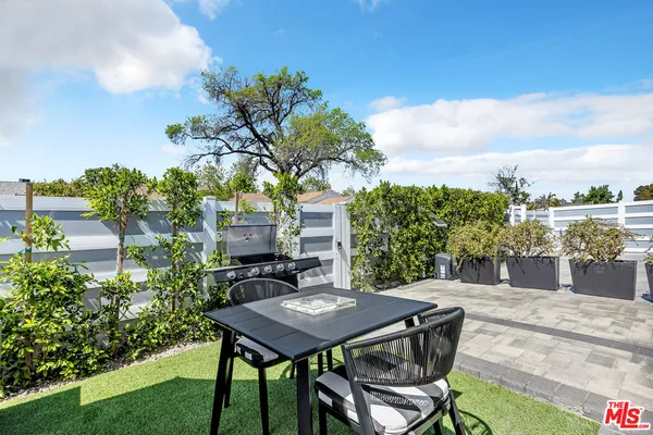 a view of a backyard with sitting area
