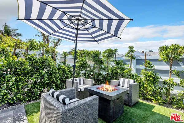 a backyard of a house with table and chairs