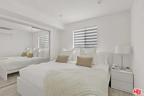 a bedroom with bed and window