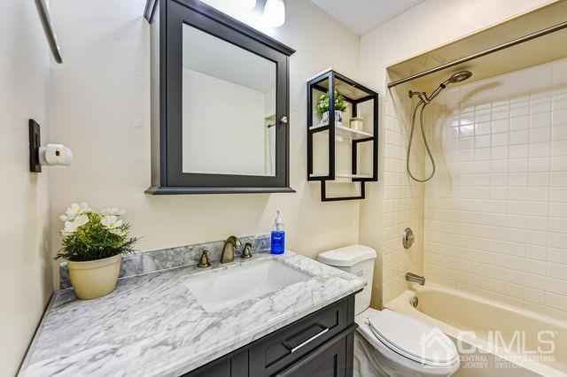 74 Briar Avenue Edison, NJ 08817 - Photo 17 of 30 a bathroom with a granite countertop sink and a mirror