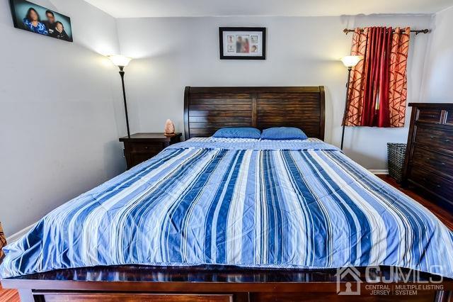 74 Briar Avenue Edison, NJ 08817 - Photo 19 of 30 a bedroom with a bed and a fireplace