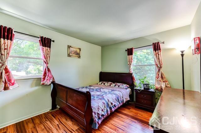 74 Briar Avenue Edison, NJ 08817 - Photo 21 of 30 a bed room with a bed window and a flat screen tv