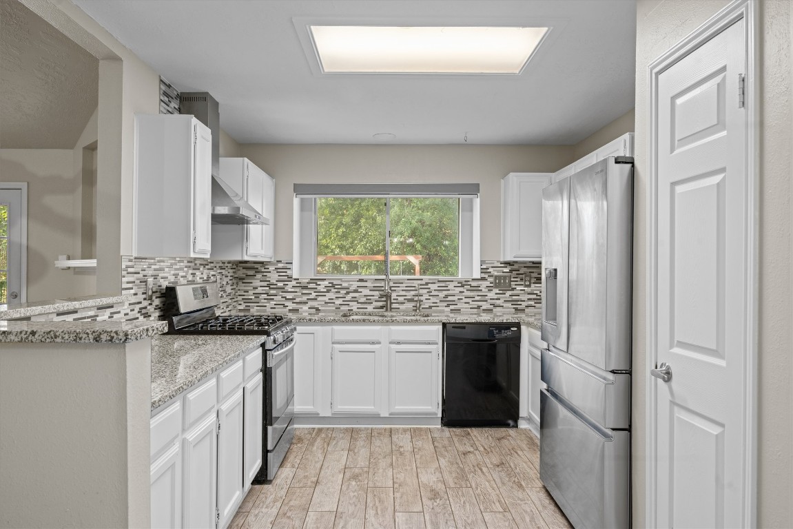 1511 Quail Run Road Pflugerville, TX 78660 - Photo 11 of 27 a kitchen with a sink stove and refrigerator