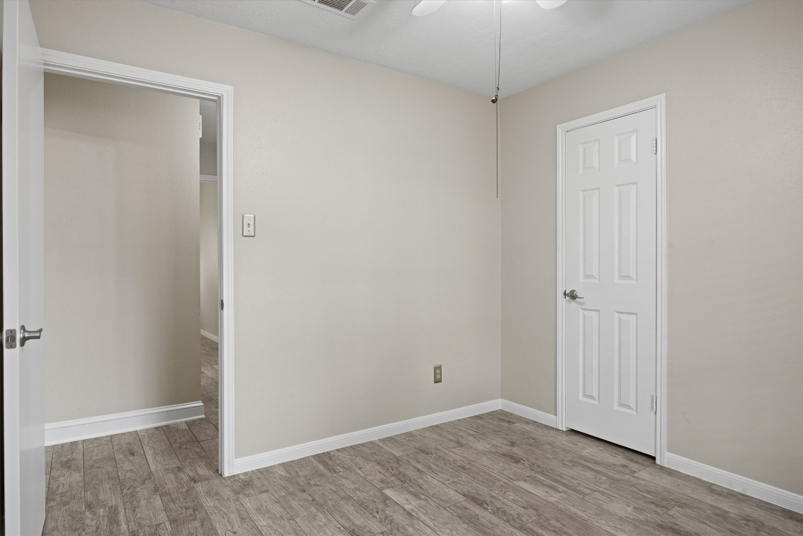 1511 Quail Run Road Pflugerville, TX 78660 - Photo 15 of 27 an empty room with wooden floor and closet