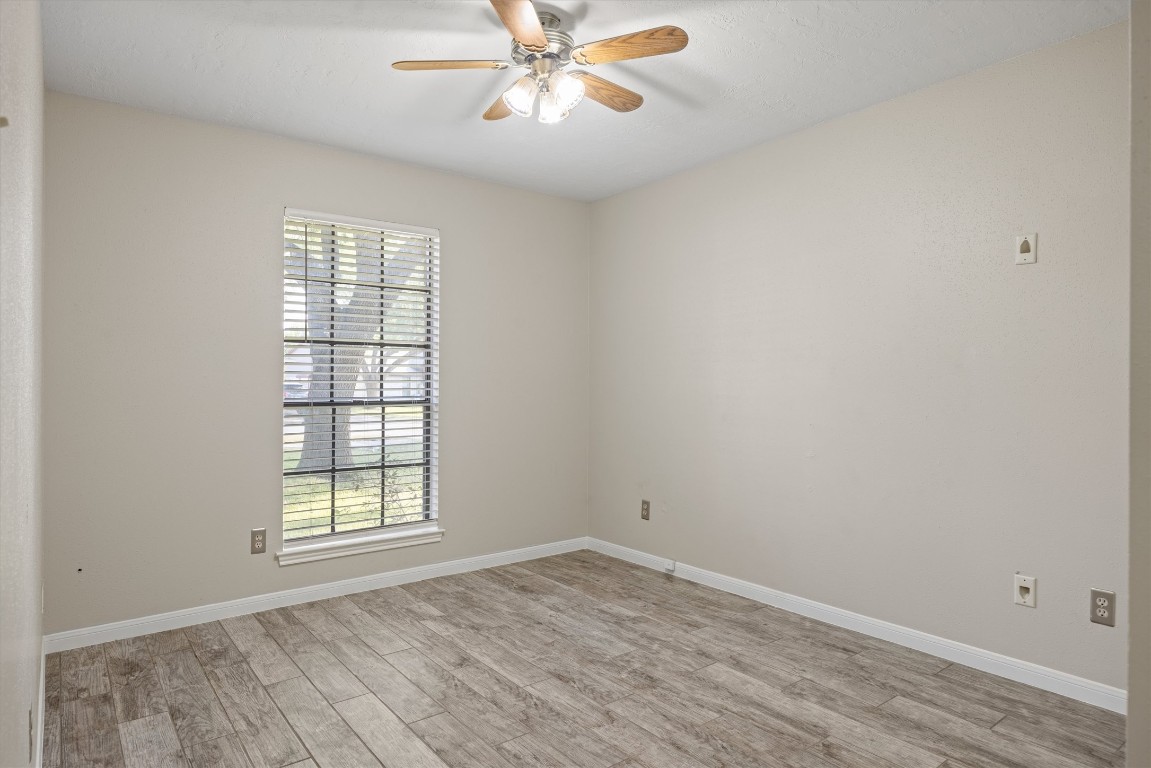 1511 Quail Run Road Pflugerville, TX 78660 - Photo 16 of 27 an empty room with windows and fan