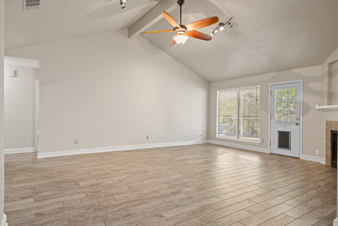 1511 Quail Run Road Pflugerville, TX 78660 - Photo 7 of 27 a view of an empty room with a window and wooden floor